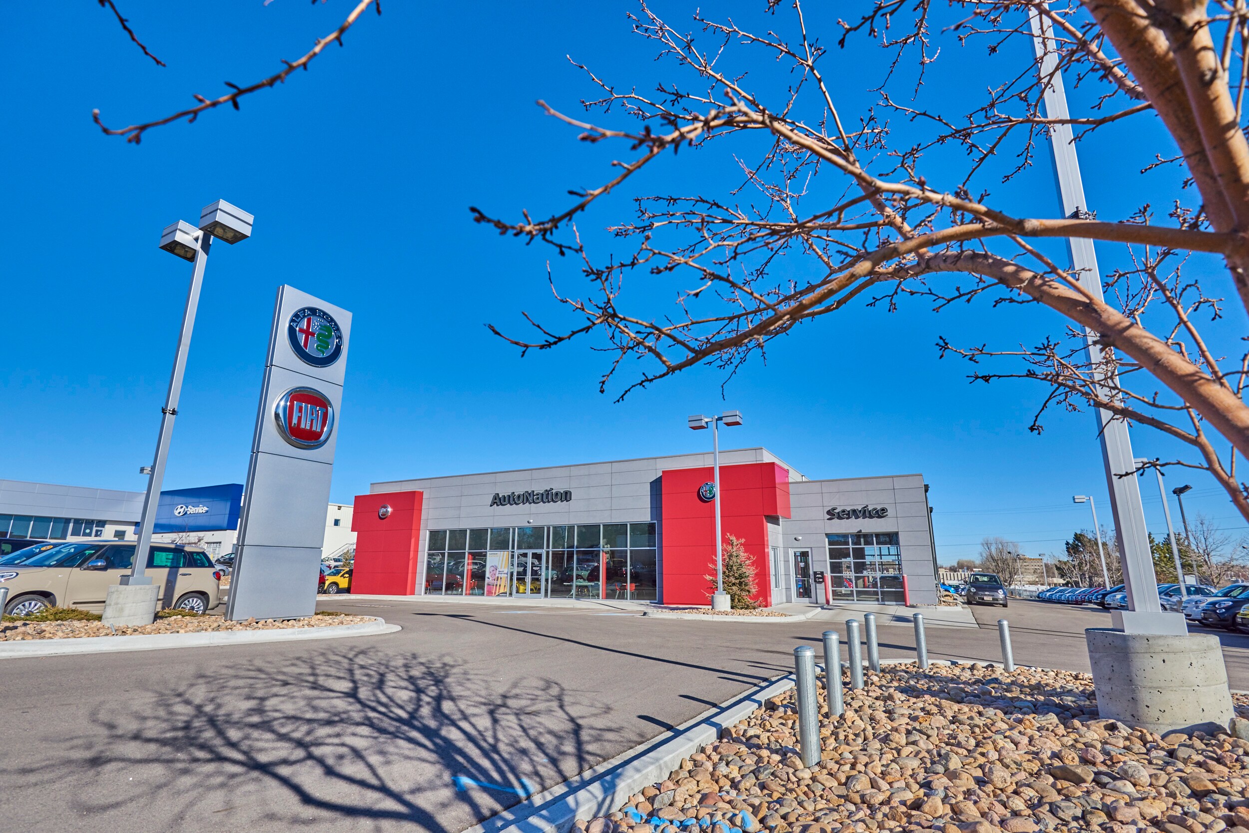 About Alfa Romeo North Denver Dealer Exterior entrance to Alfa Romeo North Denver dealer during the day