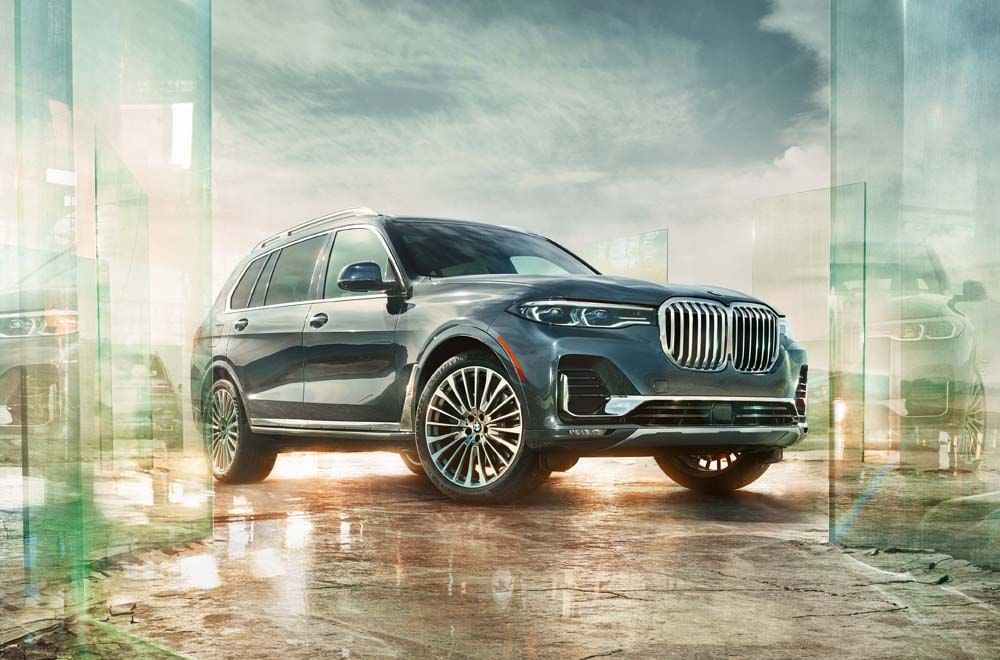 Learn more about the BMW SUVs with 3rd row seating Image of a BMW SUV against an artistic backdrop