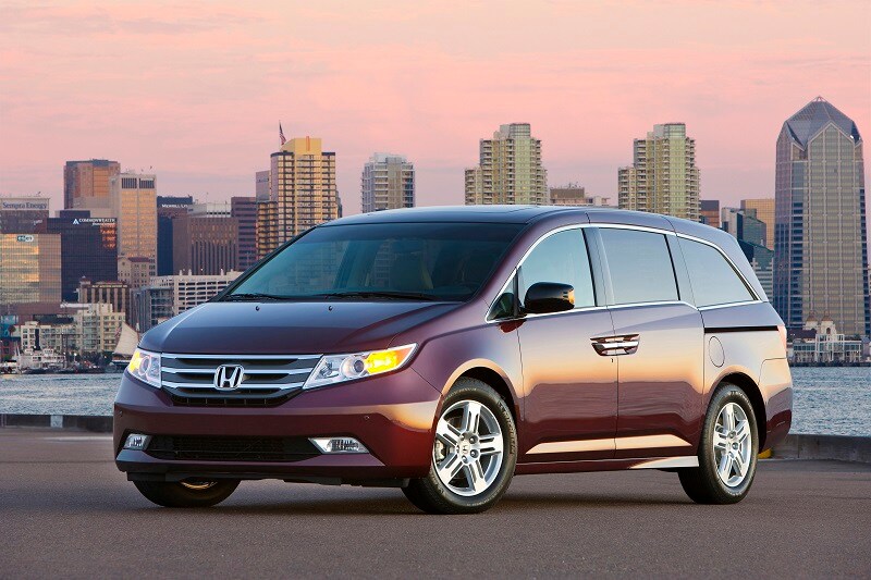 Read 5 Used Cars Under $5,000 View of a used Honda Odyssey van against a city backdrop