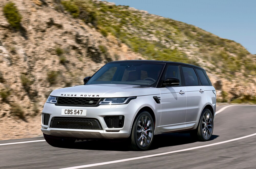 Learn more about Land Rover SUVs with 3rd row seating Image of a Range Rover SUV driving around a curved bend