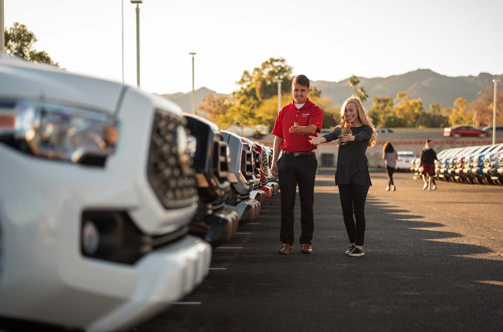 Get the best advice for buying a new or used car A woman browsing a line of cars with an AutoNation team member