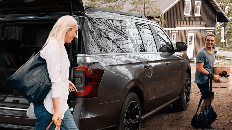 Learn about financing options available at AutoNation Ford Burleson with your ITIN number Exterior shot of a man & woman exiting a Ford Explorer