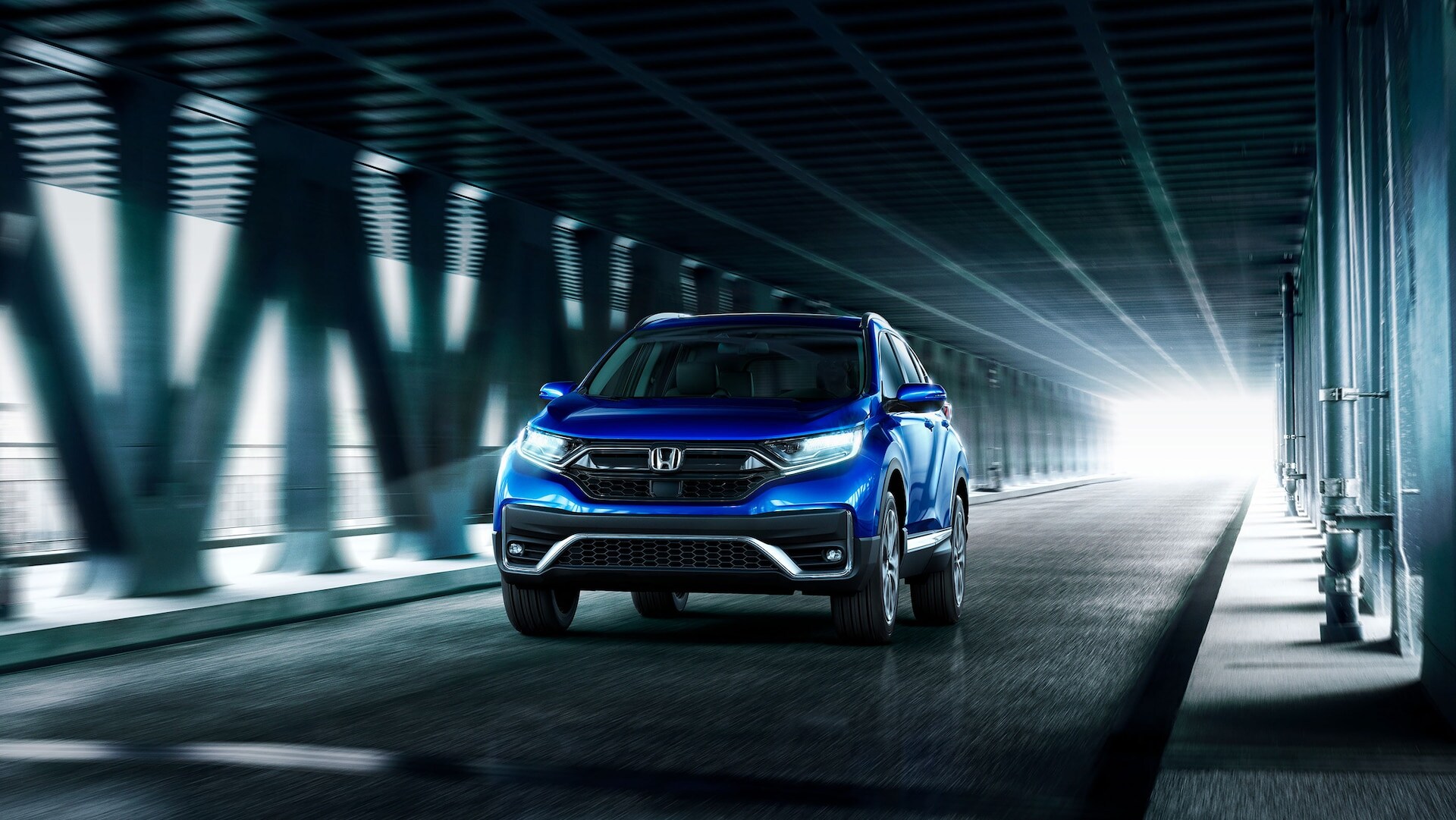 Honda Frequently Asked Questions Blue Honda CR-V speeding through a tunnel