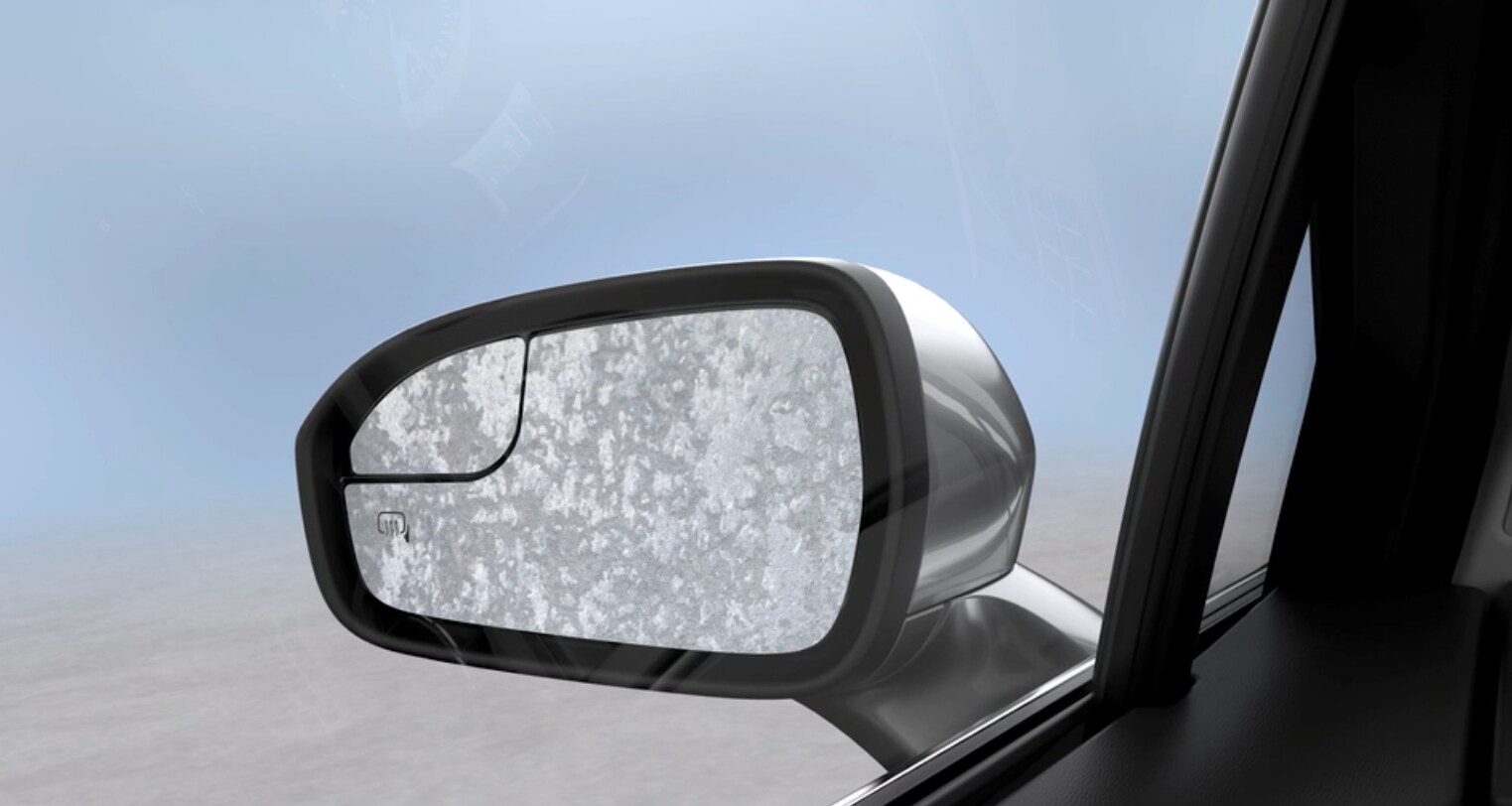 Ford Heated Outside Rear View Mirrors An image of a rear view mirror on a Ford vehicle currently frosted over with ice.