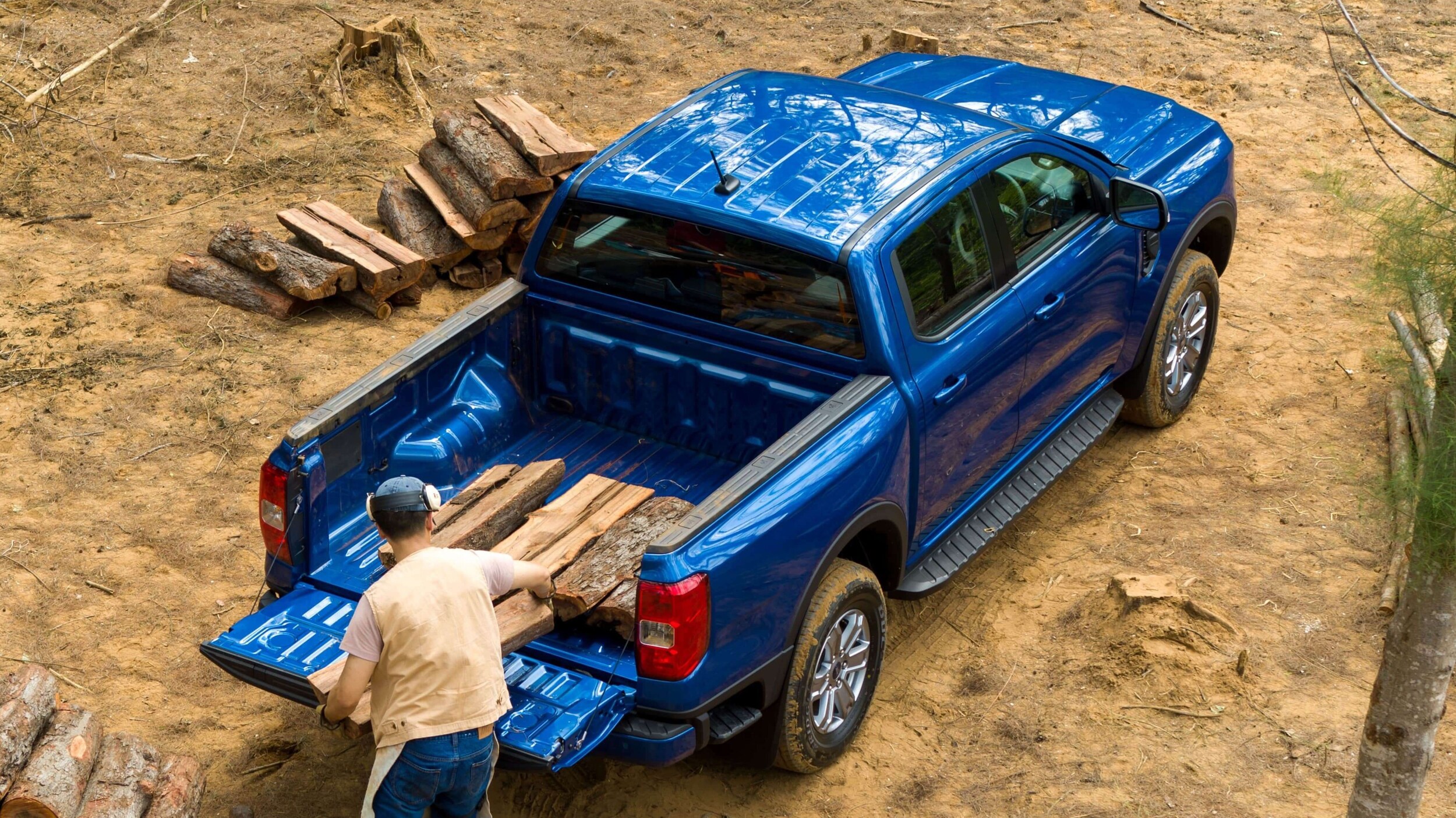 Learn about the cargo bed of the Ford Ranger Exterior shot of a Ford Ranger cargo bed being loaded with lumber