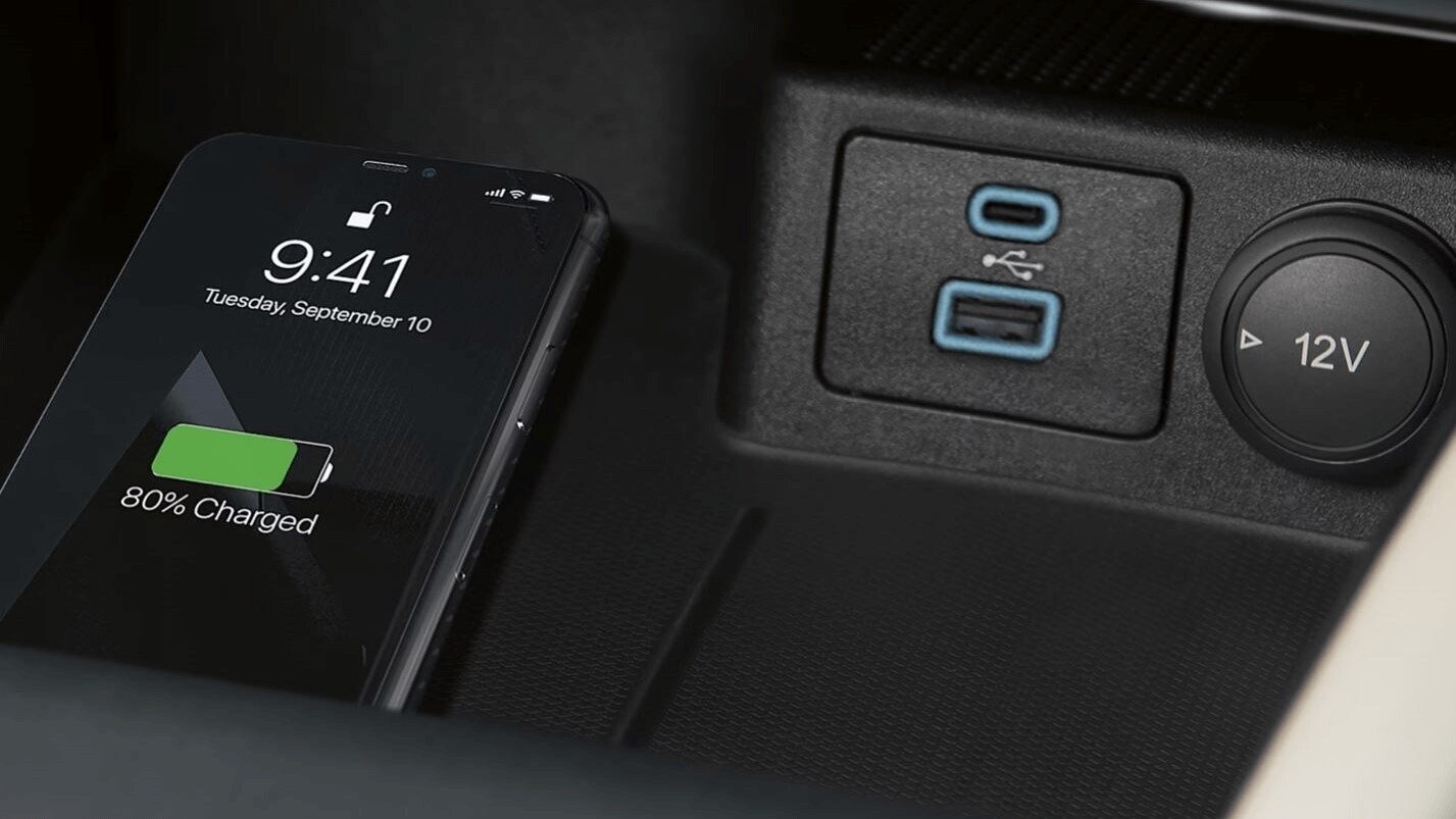Learn about the wireless charging pad available in Ford vehicles Interior shot of an iPhone being charged wirelessly on Ford's charging pad