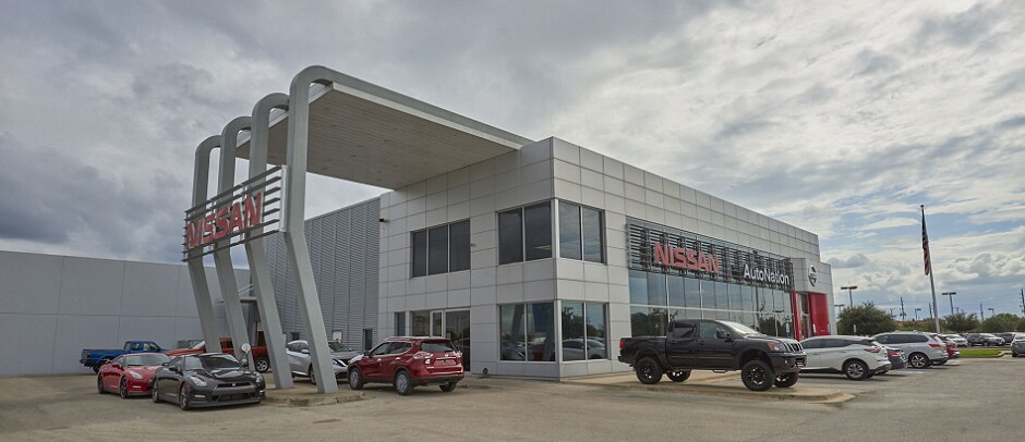 Exterior entrance to AutoNation Nissan Katy dealer during the day