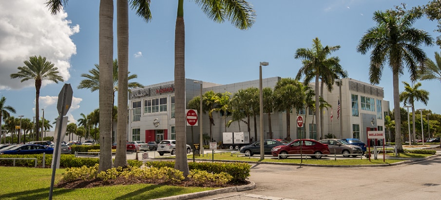 Exterior entrance to AutoNation Nissan Kendall dealer during the day
