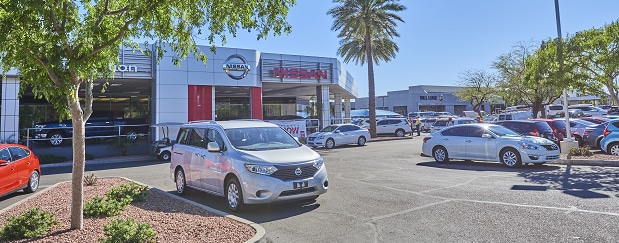Exterior entrance to AutoNation Nissan Tempe dealer during the day