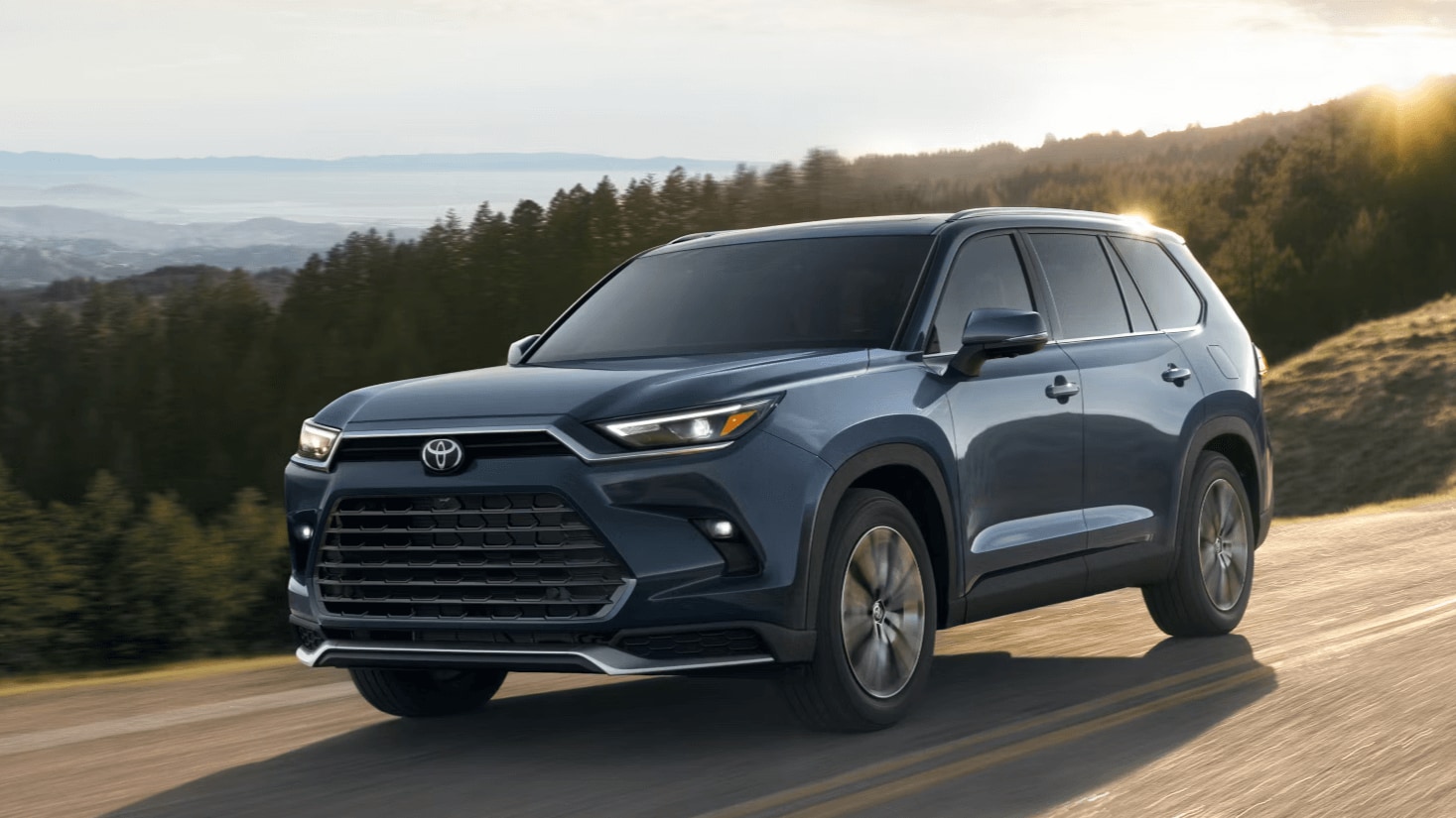 Learn about the 2025 Toyota Grand Highlander Toyota Grand Highlander driving down a road