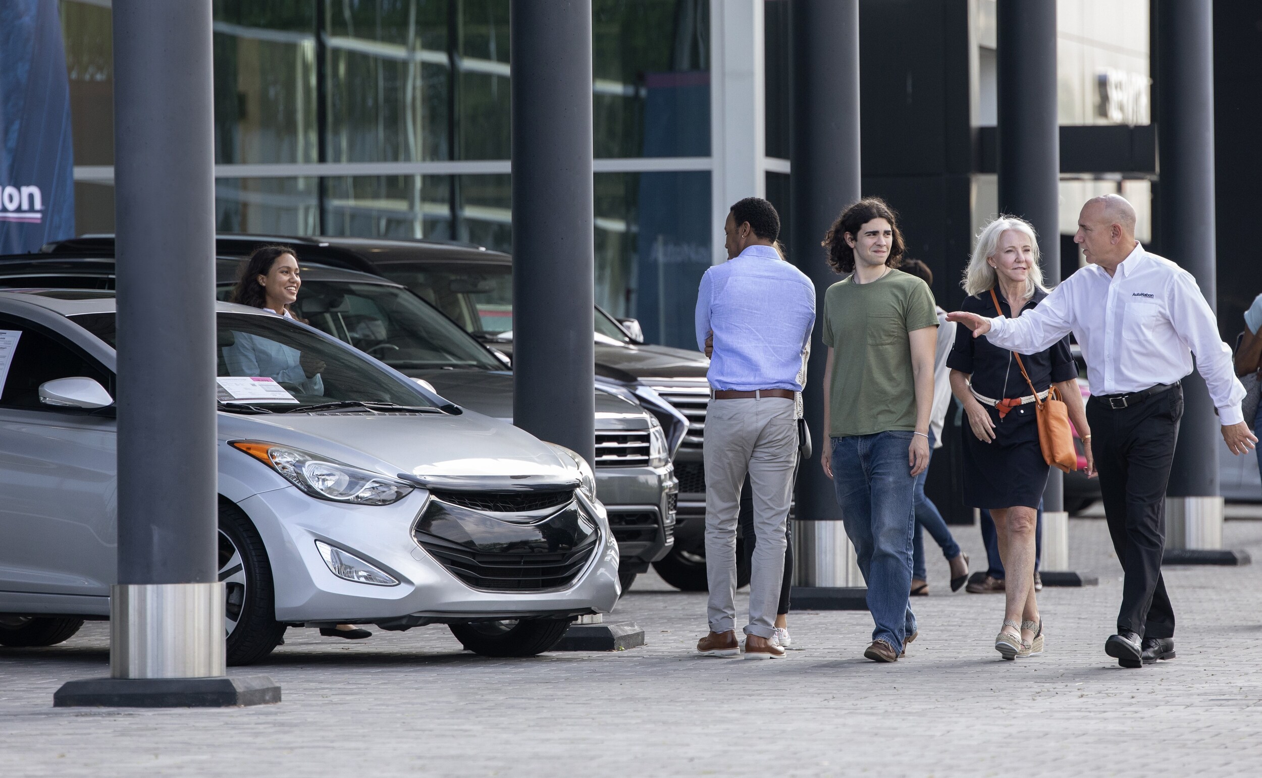 Family looking for used car at used car dealership
