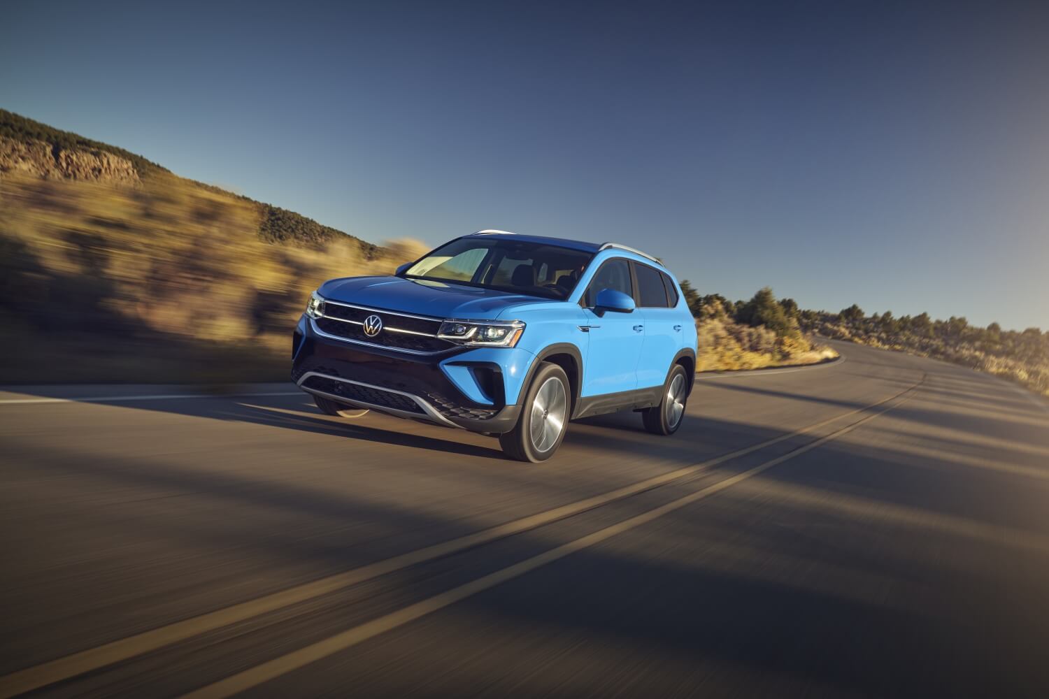 2022 VW Taos in Cornflower Blue outside a modern home