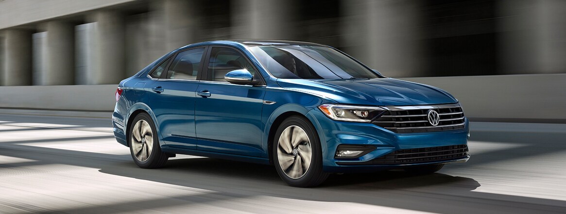 2019 Volkswagen Jetta A look at the passenger side of the all-new VW Jetta as it's driving down the road