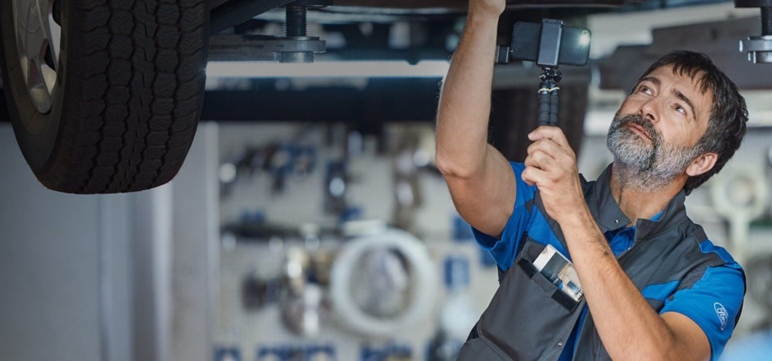 With Ford Express Service, you can get essential vehicle maintenence service without an appointment! A service technician checking a Ford.