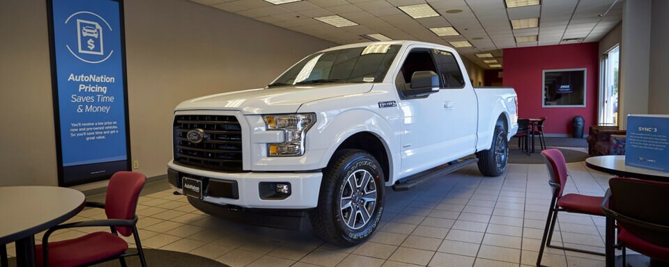 AutoNation Ford White Bear Lake Finance Center & Showroom AutoNation Ford White Bear Lake finance center and showroom with a new Ford F-150 truck for sale