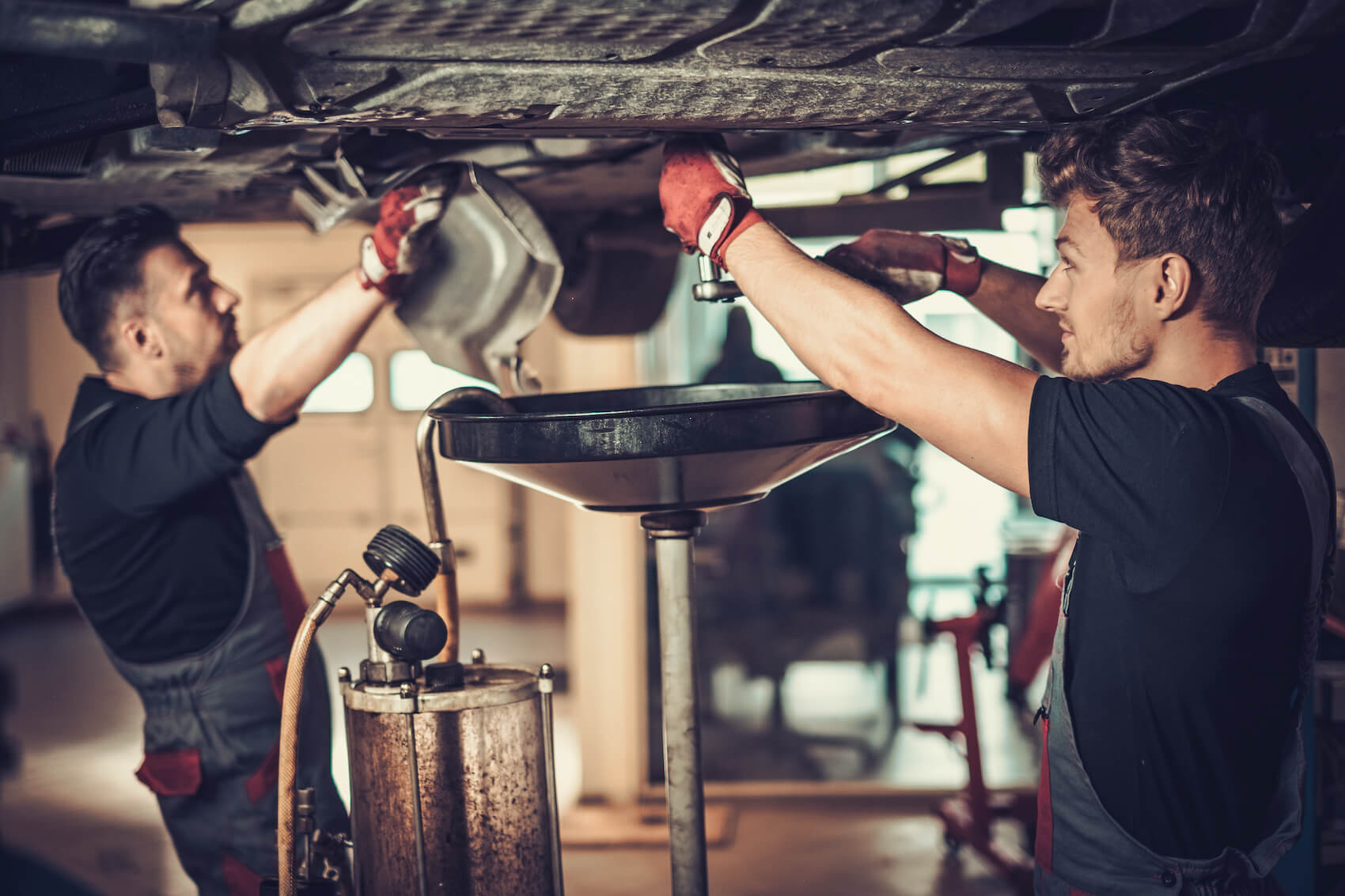 Service Techs under car changing oil
