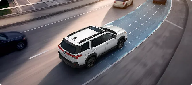 A white Subaru Outback holding its lane with adaptive cruise control graphics on the road