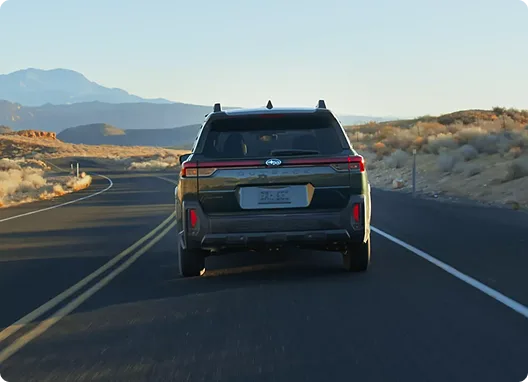 Rear view of a Subaru Outback on a straight desert highway