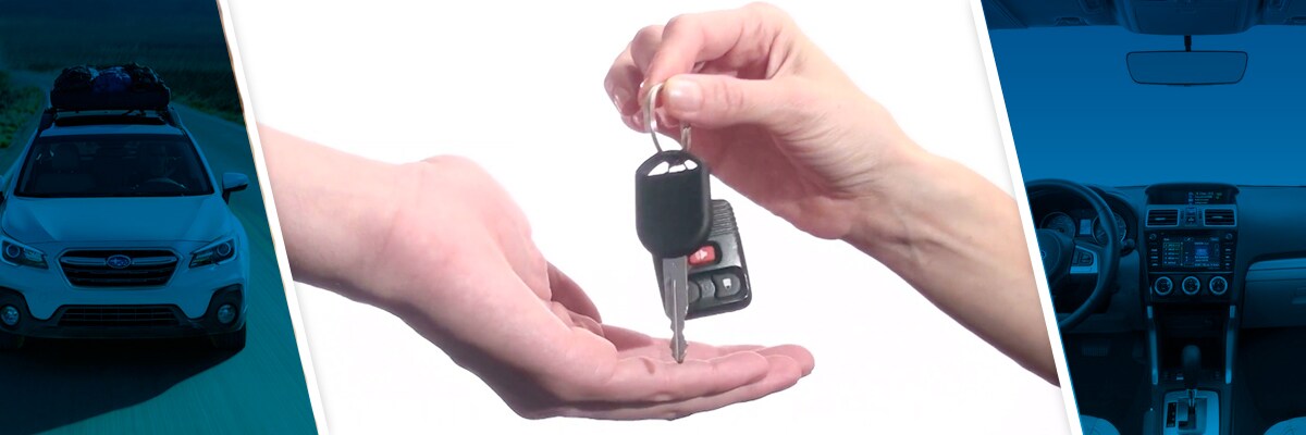 Turning over keys into a new Subaru.