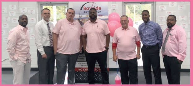 men-wering-pink-shirts-in-a-line.jpeg