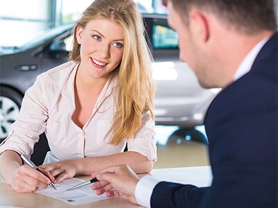 Woman signing paperwork