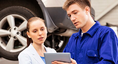 Photo of Becchmont Toyota service technician showing a customer their vehicle details and providing convenient service