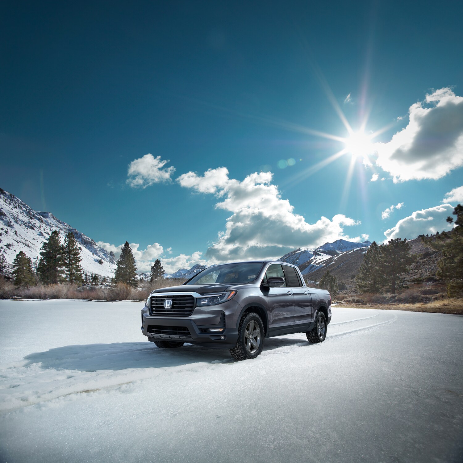 2023-Honda-Ridgeline-RTL-Truck-L06.png silver Honda Ridgeline truck parked in a field of snow