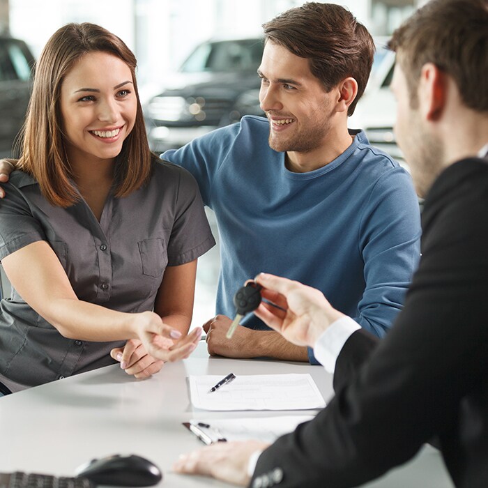 young couple getting car keys car loan.jpg