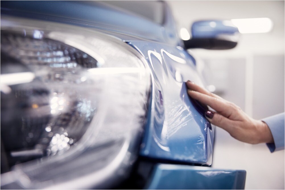 Hand on damaged and scratched Volvo front.jpg