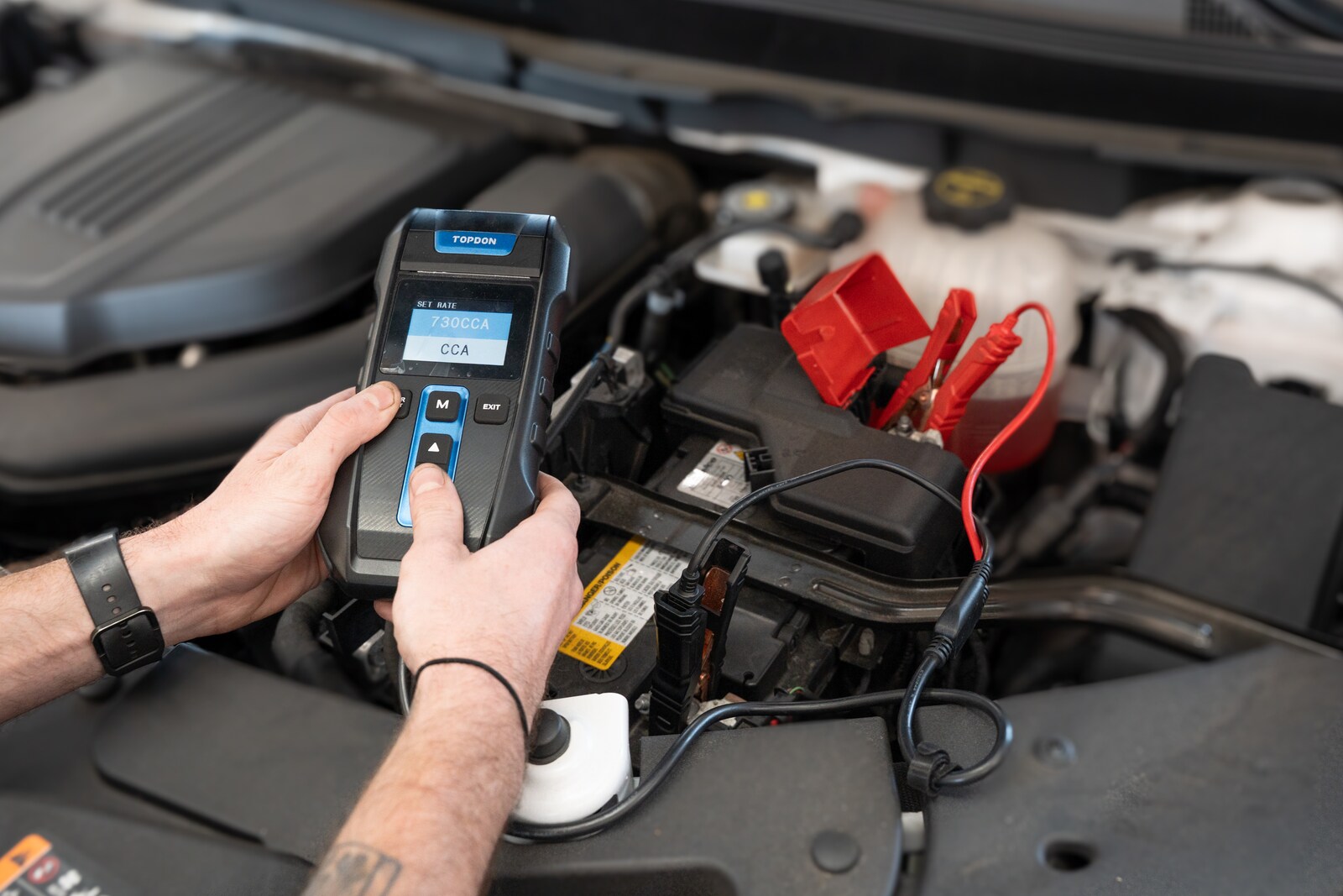 Technician testing a vehicle battery