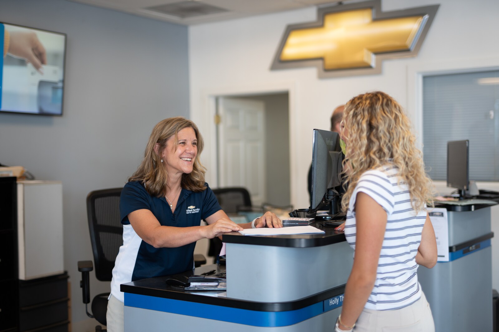 Service advisor greeting a customer in the Bergey's Chevrolet service drive