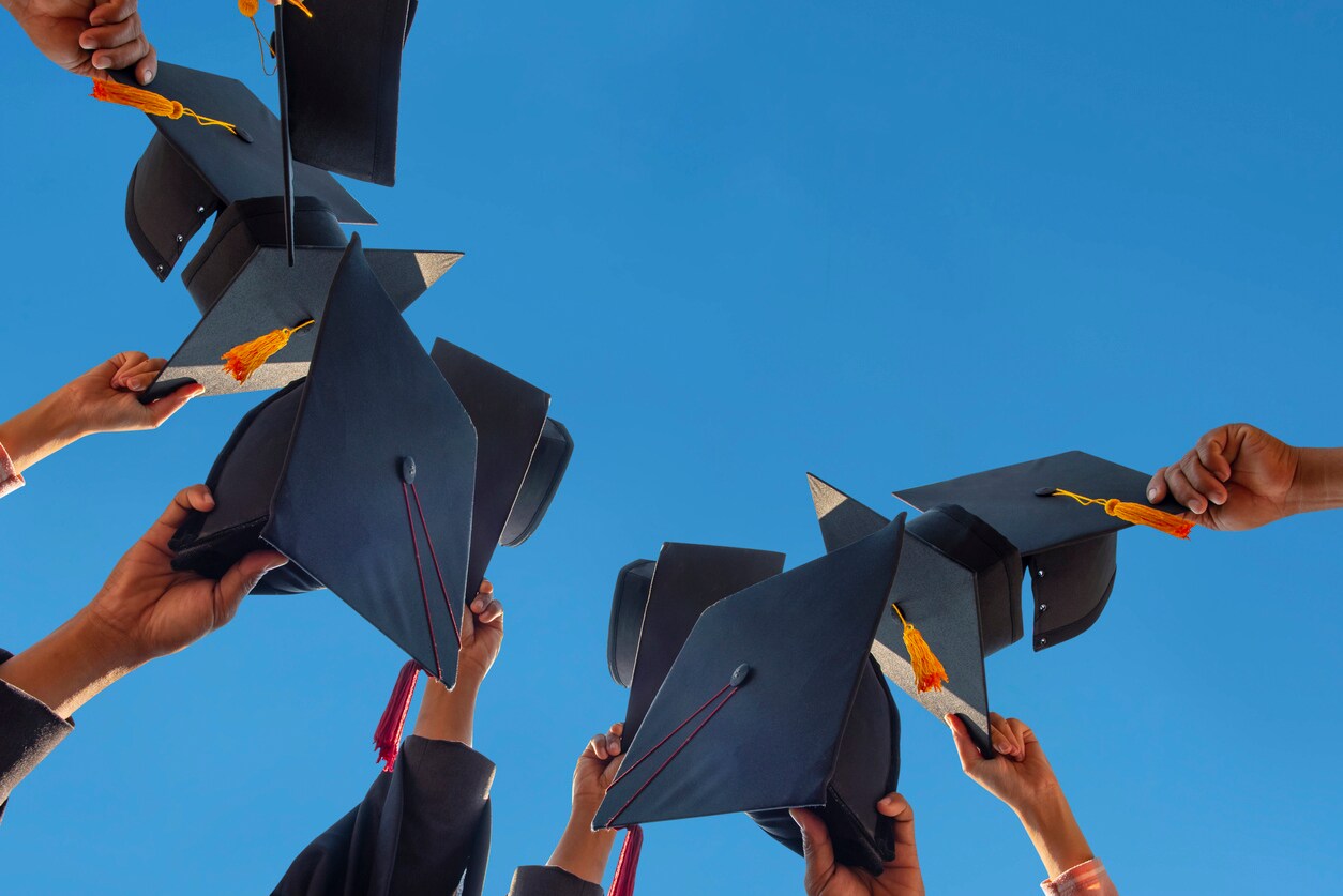grads throwing their caps in the air
