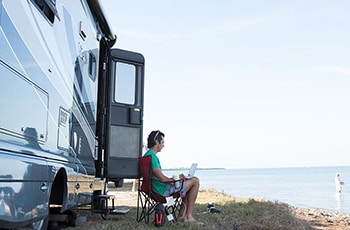 RV and person on computer