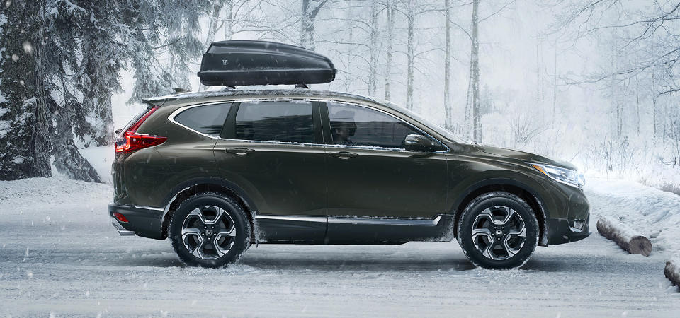 Honda CR-V Test Drive Honda CR-V in winter with storage container on top.