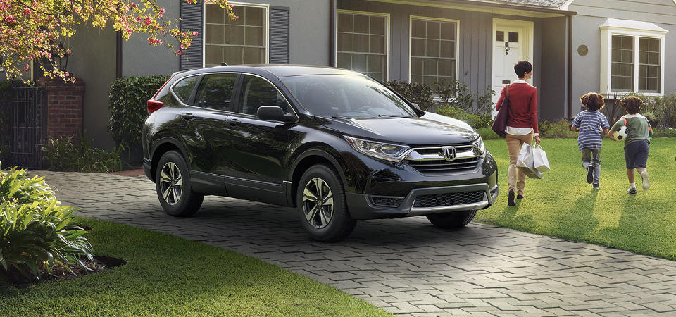 Safety Features of the Honda CR-V Image of a family next to the Honda CR-V