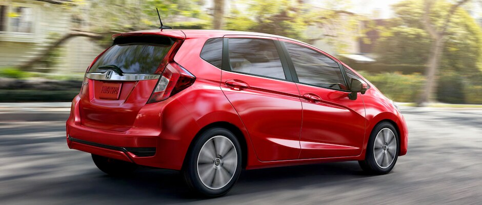 Test Drive a 2018 Honda Fit Today A red 2018 Honda Fit driving down a street