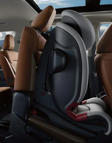Nissan Pathfinder EZ FLEX second-row seat sliding forward with a child seat installed for third-row access