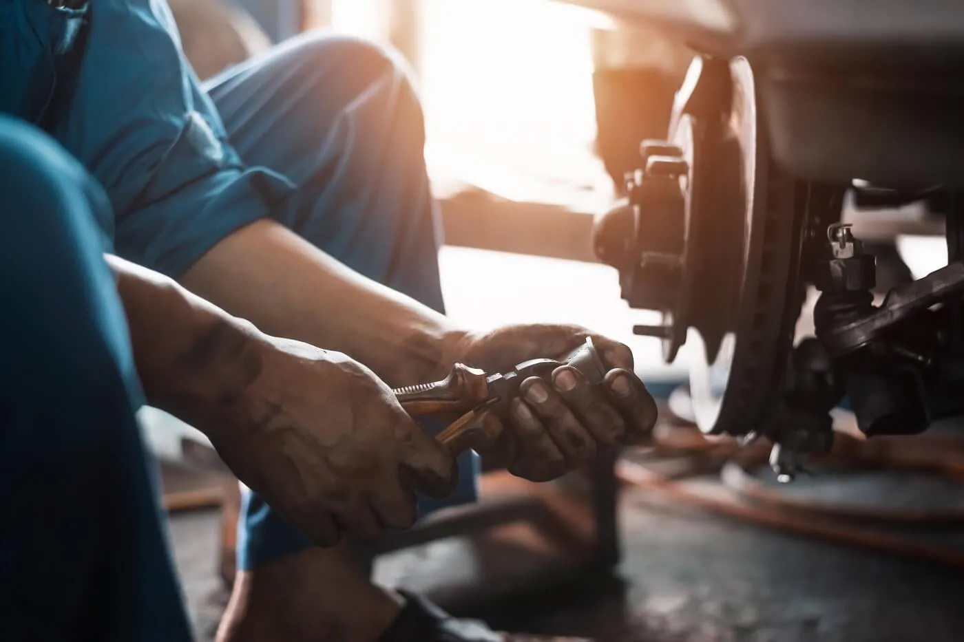 Service Technician Fixing the Brakes on a Chevy