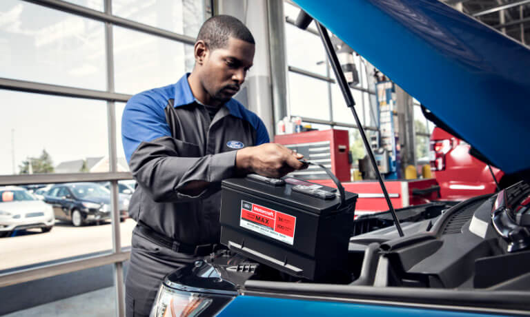 Ford Service technician replacing battery