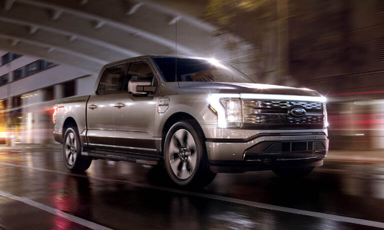 2022 Ford F-150 Lightning exterior driving in city at night