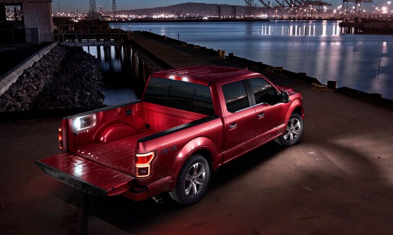 2019 Ford F-150 Exterior night at pier with tailgate down and lit empty bed