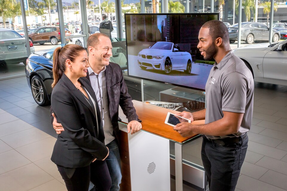 BMW genius answering car buying questions for couple.jpeg