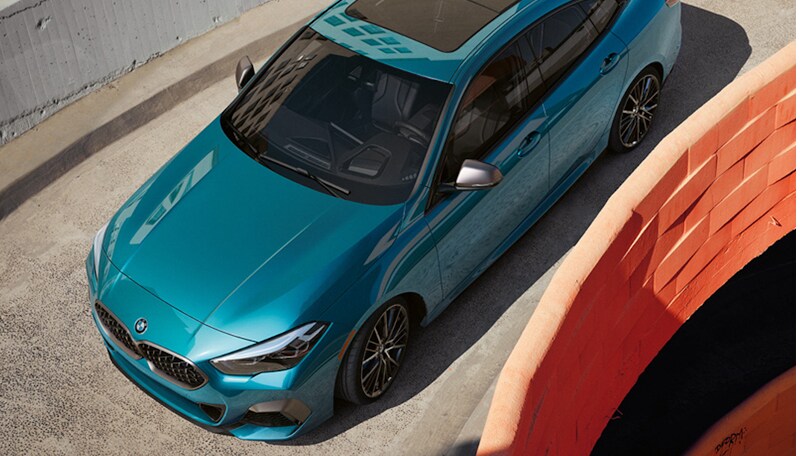 Blue Block.jpg A blue metallic BMW 2 Series Gran Coupe driving down
parking garage ramp.