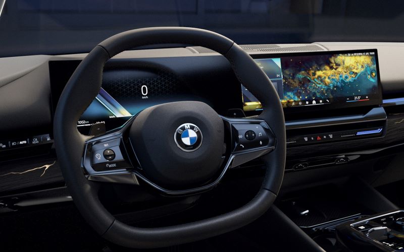 5 series interior with steering wheel and curved display.