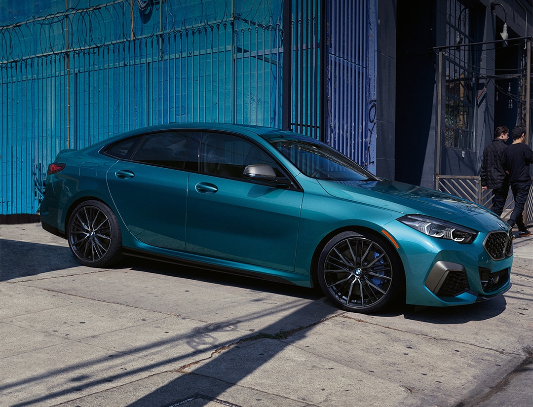 A blue metallic BMW 2 Series Gran Coupe pulling out of
alley