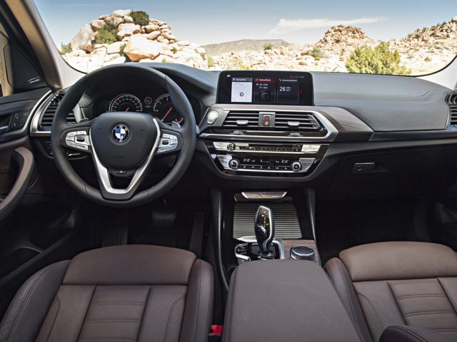 New-2023-BMW-X3-Dashboard.jpg BMW X3 front seats with steering wheel and dashboard.