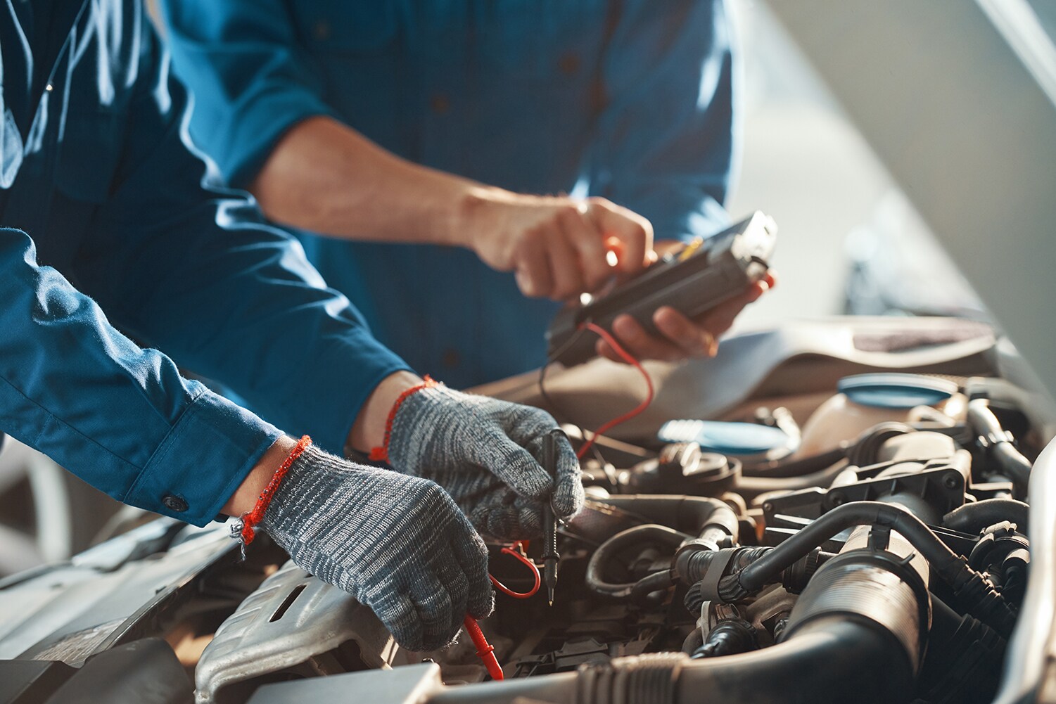 BMW of Rockville is a car dealership near Potomac MD | 2 men fixing engine