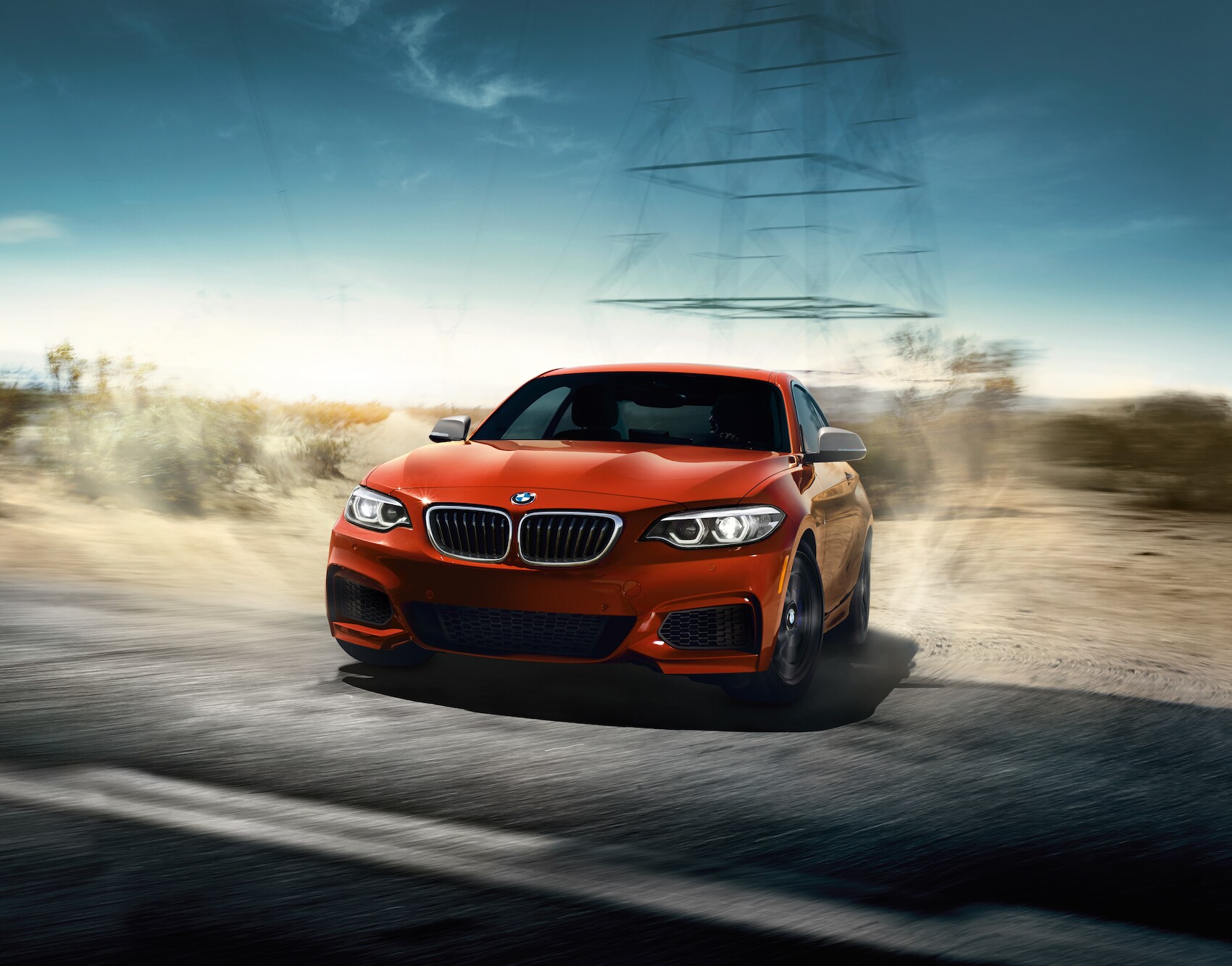 BMW of Rockville is a car dealership near Glen Echo MD | Red 2018 BMW 2-Series driving on dirt