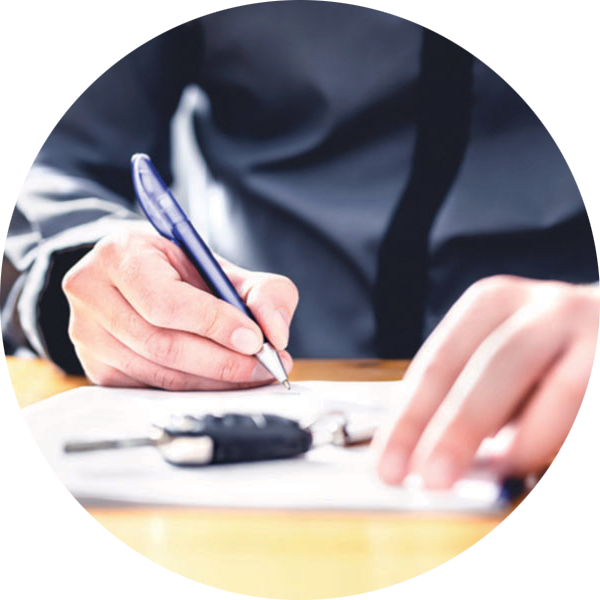 Selling Your Car A person signing a form with keys sitting on the table