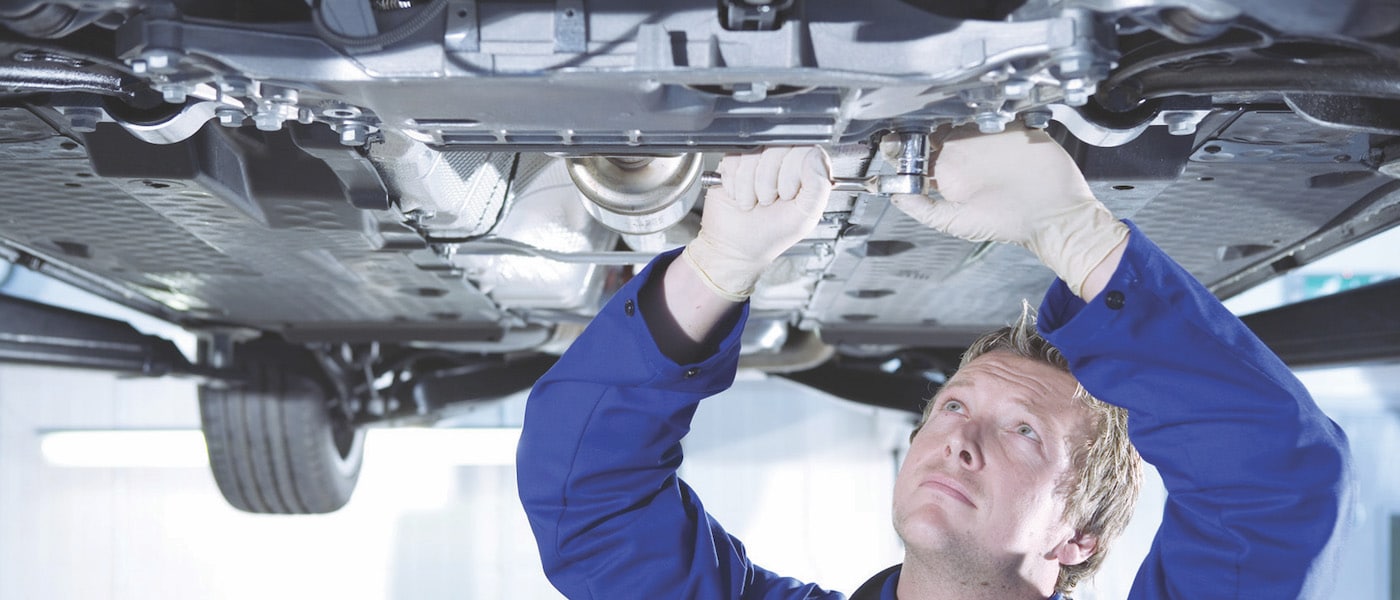 Ford Oil Change A mechnanic working under a car